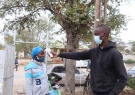 Mmoloki Malemane (right) checking a patient’s temperature before they enter the hospital as part of his Covid-19 pre-screening routine.