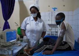 1A nurse performing checks on a diabetic patient in Abuja