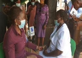 Ogun State Commissioner for Health, Dr. Tomi Coker checking her Blood pressure during the Launch of NHCI in Ogun State