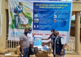 WHO officials handing over COVID-19 Information, Communication and Education material to election officials in Arua city. WHO officials handing over COVID-19 