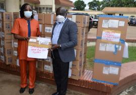 Dr. Wilhelmina Jallah, Health Minister receiving donated items from Dr. Peter Clement, WHO Country Representative