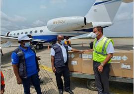 The Piolot of Johnson & Johnson Flight that brought in first batch of the EVD vaccine formally hading over the consignment to the WHO Representative in Sierra Leone at the Lungi International Airport 