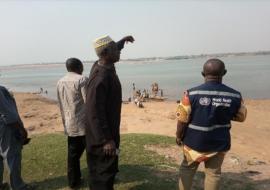 Abinsi Community leader, Garba Yakubu showing WHO SCai,(Benue State) the river where thy get their drinking water.