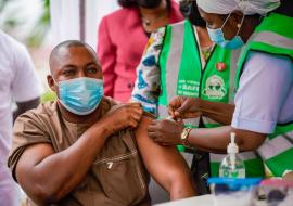 Alhaji Hassan a police officer receiving COVID-19 vaccine during the flag-off of the second phase covid-19 vaccination at FMC Jabi, Abuja.j