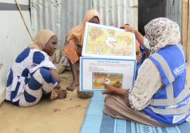 A member of the community health champion providing interpersonal risk communication messages on Cholera, Covid-19, Measles, Malaria among other to some women in IDPs camp. Photo-credit: Kingsley/WHO 