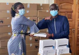 Dr Sally Ann Ohene DPC Officer presenting the tablets to Dr Kwame Amponsah-Achiano, EPI Manager, GHS