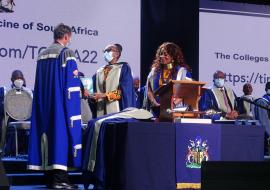 Professor Fagan (left) is presenting a memorable gift from the CMSA to Dr Matshidiso Moeti. 