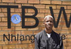 Siphephelosethu Ntjangase poses outside Nhlangano health center where he is receiving treatment