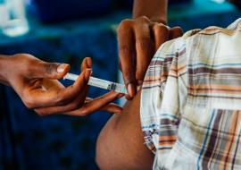 A community leader in Manyara Region receiving COVID-19 vaccine after the sensitization meeting