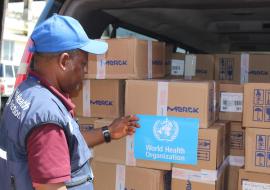 WHO staff member inspecting the medical supplies prior to offloading at the Ministry of Health