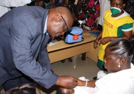 WHO Representative Ghana Dr. Francis Kasolo, administering polio vaccine to a child to kick start the immunization campaign