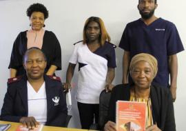 From left front: Justina Shoopala,Senior Registered Nurse at the Rundu State Hospital and Mrs  Angaleni Kangayi, Regional Chief Social Worker; Back row from left Florence Hangula, District Social Worker, a health worker and Mr. Mbware Ditmar Enrolled Nurse.  discussing the clinical handbook. 