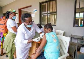 A mother recieving the first dose of COVID-19 vaccine_