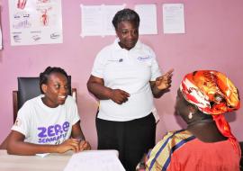 Primary healthcare workers using WHO-PEN module to educate a woman about breast cancer before screening her at the Sunyani Municipal Hospital