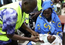 A health worker administering measles vaccine at Al-Sabah Children's Hospital in Juba 