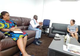 Dr. Clement Peter stresses a point while Ms. Sandra  Bird (right) and Dr. Musu Duworko pay close attention