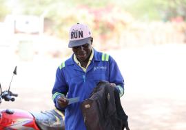 Kajobe smiles as he recieves his vaccine certificate