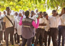 WHO Country Rep, Dr. Jane Maina, talks to students during the MDA campaign