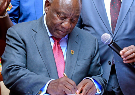 His Excellency President of the Republic of South Africa signing the NHI Bill into law