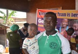 hedrick Barlee, with his one-year-old son Blessed Barlee, at the vaccination campaign