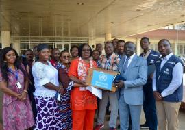 Dr Catherine Cooper, representing the Ministry of Health receiving the donation from WHO Rep, Dr Clement Peter.