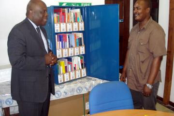 WHO Representative, Dr. Rufaro Chatora, handing over the Blue Trunk Library to the Principal of the Nursing School