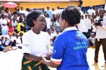 Rwanda Biomedical Centre Director General, Dr. Jeanine Condo congratulating a former TB patient after testimony