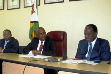 Deputy Minister Chimedza(c) following attentively while Dr David Okello presents his statement during the press conference