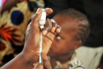 Young Gambian child waiting to be immunized with MenAfriVac