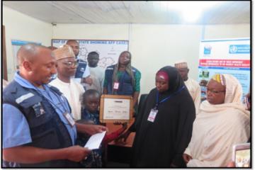 Presentation of plaque-certificate to widow of Late Isyaku Yakubu, by WHO State Coordinator in Niger State