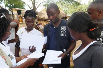 Ebola contact tracing team at work in the quarantined village, Bombali district, Sierra Leone.