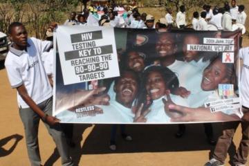 The marchers displaying their banners showing the national VCT Day 2016 campaign theme in Mumbwa district