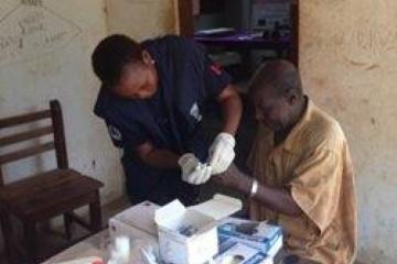 A laboratory technician at WHO collecting blood specimens for testing Lymphatic Filariasis