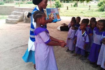 Grace Hyeladi Durkwa talks to young children in their school about how they can protect themselves from cholera in Mubi North, Nigeria (Photo courtesy Grace Hyeladi Durkwa)