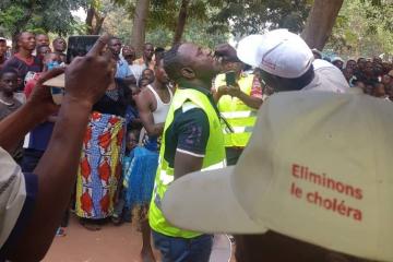 A local official receives a dose of oral cholera vaccine in Tshilenge, July 2019