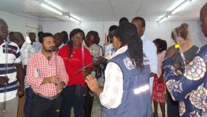 Mr Freeman showing the participants on how to use water turbidity tube for measuring the clarity of water