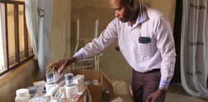 Umar Musami, Psychiatrist, Federal Neuro Psychiatric Hospital looking at medication for mental disorders in Bakass Camp in early March 2018