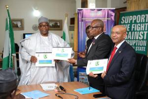 Governor and UN Delegates displaying the signed MOU Document