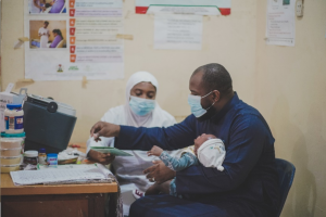 Mr Aliyu Bello and his daughter to receive the routine Immunization 