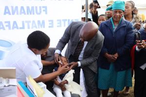 WHO Lesotho Country Representative, Dr Richard Banda vaccinating a baby during the official launch of the African Vaccination Week in Lesotho