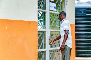 An Ebola survivor walks to the survivors' clinic in Kassanda