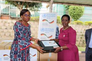 Dr Christine Musanhu, WHO Uganda OIC, handing over IT equipment to Dr Diana Atwine, the Permanent Secretary at the Uganda's Ministry of Health