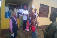 A young girl displaying the sign language of ‘l love you’, the others are looking at the interpreter on the other side