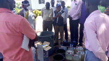 Alex Sokemawu WHO WASH and Logistics technical lead demonstrating water quality control testing