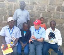 Dr Joel Breman, ICT lead speaks to a boy in Ntulele, Narok County, during  the GW evaluation