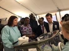 The Minister of Health and WHO officials shown a demonstration by the labarotory technician. Photo: EMLab/Thomas Strecker 