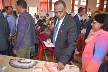 Dr Musango, WHO Representative, looking at the health education materials 