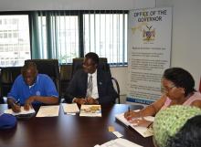 Mr Petrus Mhata Health  Emergency Focal Person  making a presentation to the Governor in the presence of Dr Charles Sagoe-Moses, WHO Representative