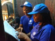 Fati Niger with WHO Health Emergencies Communication Officer, Chima Onuekwe reviewing a script in a recording session in a Maiduguri, Borno state. 