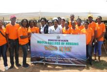 Health workers displaying banners with key messages on TB